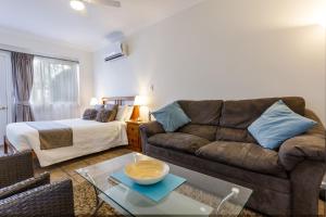 a living room with a couch and a bed at Inn The Tuarts Guest Lodge Busselton Accommodation - Adults Only in Busselton
