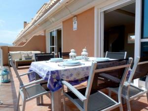 a table and chairs on a balcony with a table and chairsktop at Mirador al Mar 56 in Denia