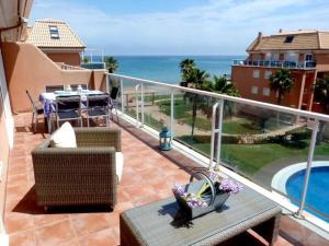 a balcony with a table and chairs and the ocean at Mirador al Mar 56 in Denia