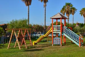 a playground with a slide and other playground equipment at ILIOS K Village Resort in Tigaki
