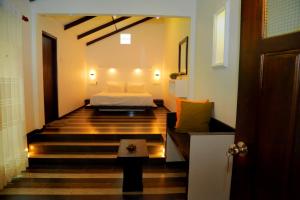 a bedroom with a bed and a staircase in a room at Midigama Holiday Inn in Midigama East