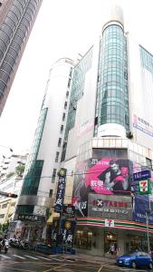 a tall building with a billboard on the side of it at Walker-Taoyuan in Taoyuan