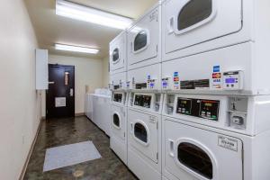 a laundry room with white washing machines in a room at Suburban Studios Huntsville University Area in Huntsville