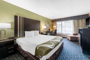 a hotel room with a large bed and a living room at Quality Inn & Suites Brooksville I-75-Dade City in Ridge Manor +22 photos