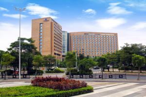 a large building with tall buildings in a city at Hotel Nikko Guangzhou - Complimentary shuttle service for concert event Baoneng&Olympic in Guangzhou