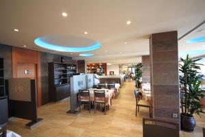 a restaurant with a dining room with tables and chairs at Hotel Risech in Roses