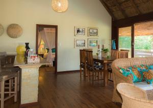 a living room with a table and a dining room at Cabo Beach Villas in Santa Maria