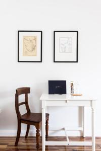a white desk with a chair and a laptop on it at A Cottage In Richmond in Richmond