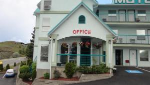 a office building with a sign that reads office at Alpine Motel in Kamloops