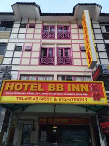 a pink and white building with a hotel bc inn at Hotel BB Inn @ Cameron in Cameron Highlands