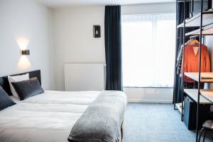 Postel nebo postele na pokoji v ubytování Hotel Carnac