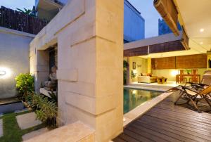 an external view of a house with a swimming pool at Sudha Villa Bali Baik-Baik in Seminyak