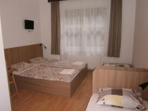 a bedroom with two beds and a window at Fanni Budapest Guesthouse in Budapest