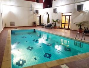 a large swimming pool with blue water at TAKIALT in Adrar