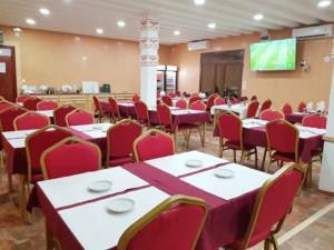 a conference room with tables and chairs and a projection screen at TAKIALT in Adrar