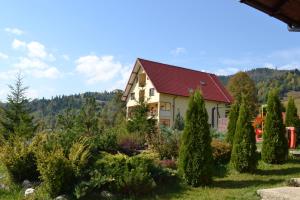 a house with a garden of trees and bushes at Pension Casa Vero in Vama