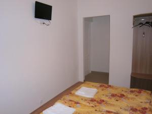 a bedroom with a bed with two towels on it at Fanni Budapest Guesthouse in Budapest