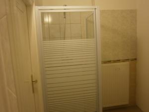 a closet with a glass door in a room at Fanni Budapest Guesthouse in Budapest