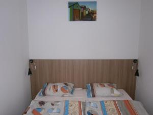 a bedroom with two beds and a picture on the wall at Fanni Budapest Guesthouse in Budapest
