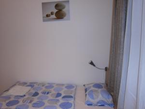 a bedroom with a bed and a picture on the wall at Fanni Budapest Guesthouse in Budapest