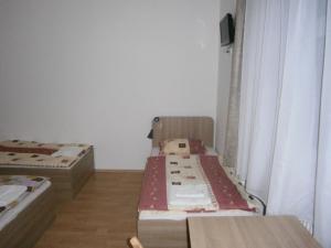 a room with two beds and a window at Fanni Budapest Guesthouse in Budapest