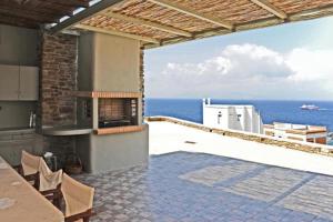 a kitchen with a view of the ocean at The Sunrise Villa in Koumáros