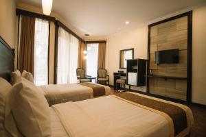 Puteri Gunung Hotel tesisinde bir odada yatak veya yataklar