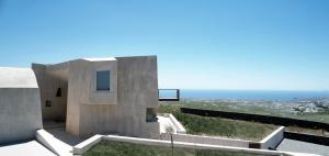 a concrete house with a view of the ocean at Albus Villas in Pyrgos