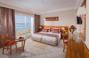 a hotel room with a bed and a balcony at Thabraca Thalasso & Diving in Tabarka