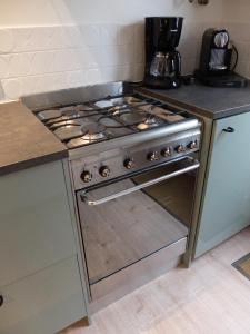 a stove top oven sitting in a kitchen at Pelt 35 in Bergen