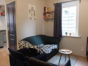 a living room with a couch and a window at Pelt 35 in Bergen