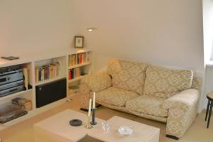 uma sala de estar com um sofá e uma mesa em Schlottmann em Keitum