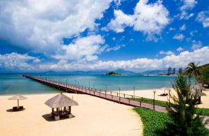 a pier stretches out into the water on a beach at Luhuitou State Guesthouse & Resort in Sanya