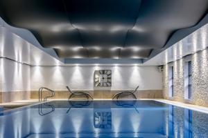 a swimming pool with chairs in a building at The Gamekeeper's Inn in Skipton