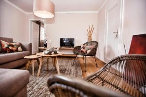 a living room with a couch and a table at Ferienhaus Hotel Hirschen Horn in Gaienhofen