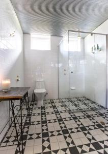 a bathroom with a toilet and a glass shower at Grand Cru Estate Homestead in Springton