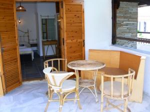 a table and two chairs and a table and a table and chairs at Hotel Rigakis in Pefkochori