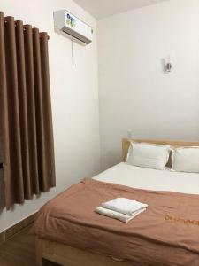 Postel nebo postele na pokoji v ubytování An Ngọc Linh Hotel