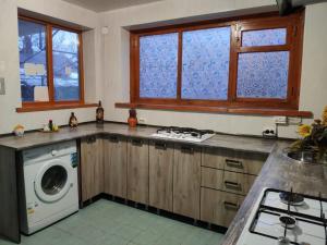 a kitchen with a washer and a washing machine at Yuzhny Briz Guest House in Yeysk