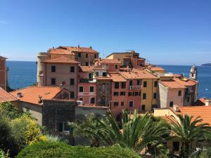 a group of buildings with the ocean in the background at Amazing Apartment in Tellaro