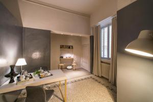 a living room with a desk and a chair at Palazzo del Papa in Siena