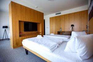 Postel nebo postele na pokoji v ubytování Hotel S-PORT Véska