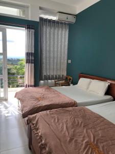 Postel nebo postele na pokoji v ubytování An Ngọc Linh Hotel