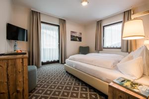 En eller flere senger på et rom på Alpen Villa Rieder