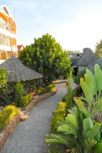 a walkway in a resort with trees and a building at Pine Breeze Getaway Lukenya in Athi River