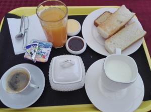 a tray with plates of food and a cup of coffee and toast at LES 2 HORLOGES in Oran