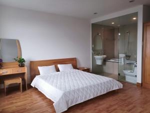 a bedroom with a bed and a bathroom with a sink at Silver Sea Tower in Vung Tau +25 photos