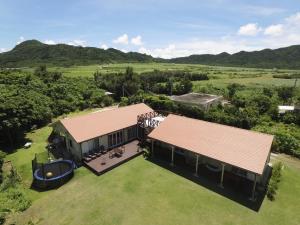 an aerial view of a house with a large yard at guest house annsea in Ishigaki Island