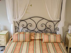 a bed with an ornate black headboard in a bedroom at Hotel Delle Rose in Rapallo