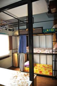 a room with three bunk beds in a room at Hikers Hostel in Plovdiv